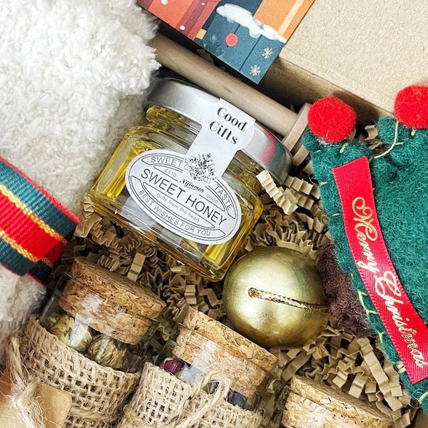 3. Christmas Tea & Cozy Gift Box – Socks, Honey, Herbal Tea, Chocolates & Ornament